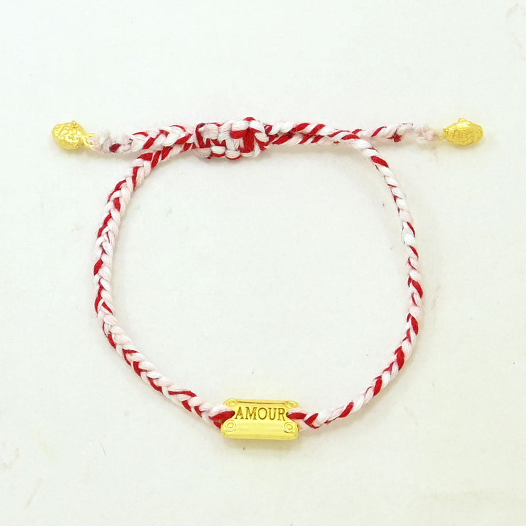 Hand-woven red and pink love thread bracelet featuring an adjustable sliding knot and gold AMOUR charm