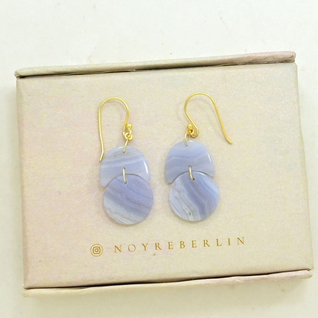Earrings with light blue gemstone