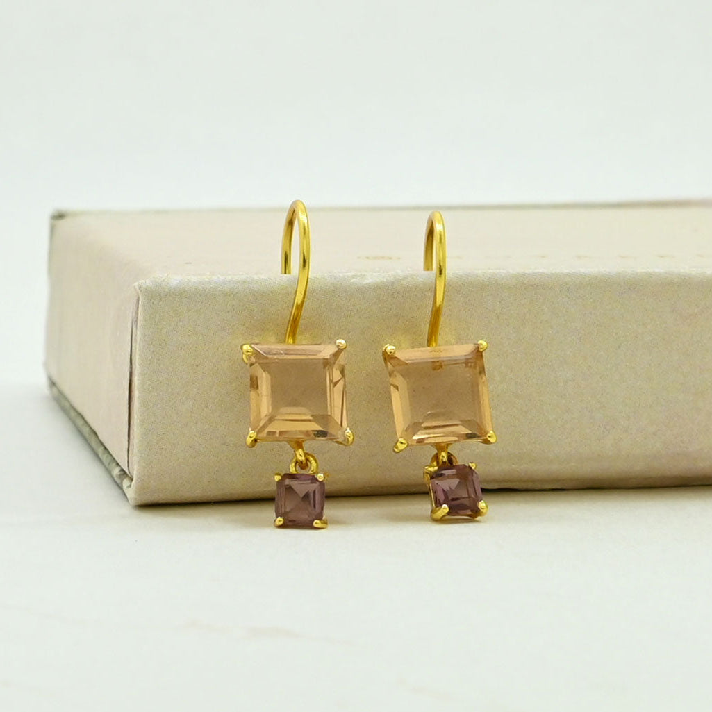A pair of gold drop earrings with square morganite and small rhodolite stones